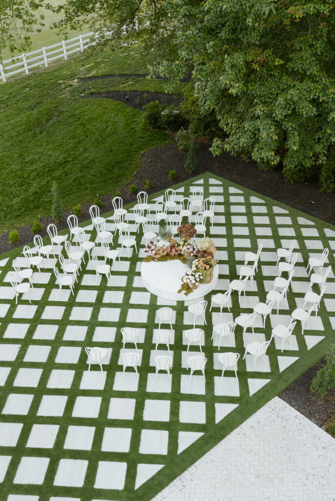 The Greenhouse at Arrows Farm green house wedding with neutral color palate drone photography of the ceremony space